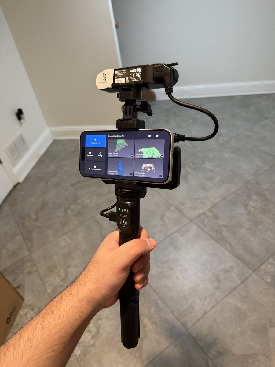 The 3D scanner held up, with the scanning app open on the phone