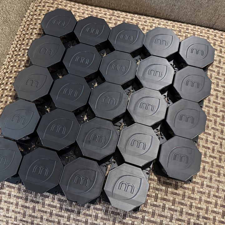Twenty-four matching black ABS fan vent covers laid out in a grid