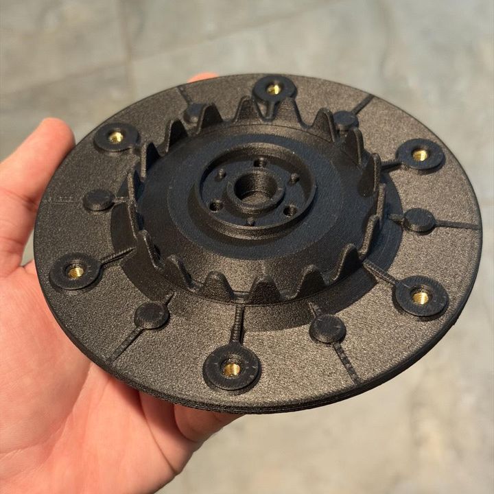 Black carbon-fibre ASA cutting disc for a robot lawn mower, with brass M5 threaded inserts